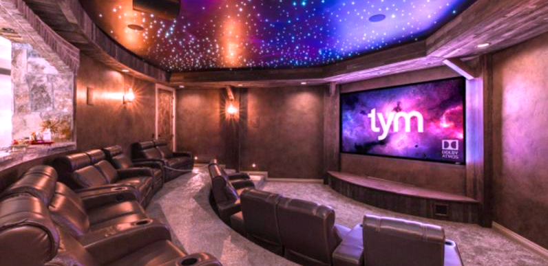 "A home theater setup with a TV, sound system, and comfortable seating for a movie night at home"