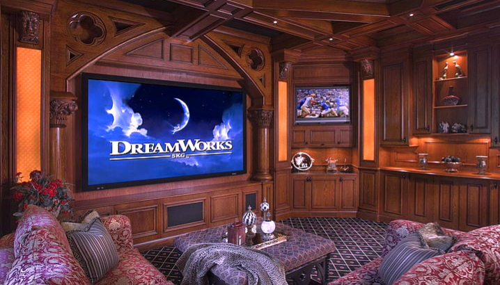 "A home theater setup with a TV, sound system, and comfortable seating for a movie night at home"